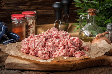 Minced meat on wooden background.