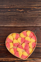 Valentines Day background with colorful candies. Jelly candies covered with sugar crystals in heart-shaped box, copy space.