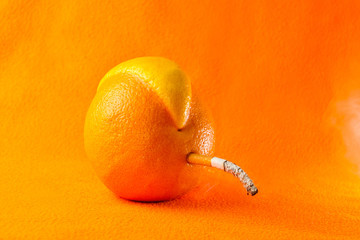 Grapefruit mutant smoking a cigarette on an orange background.