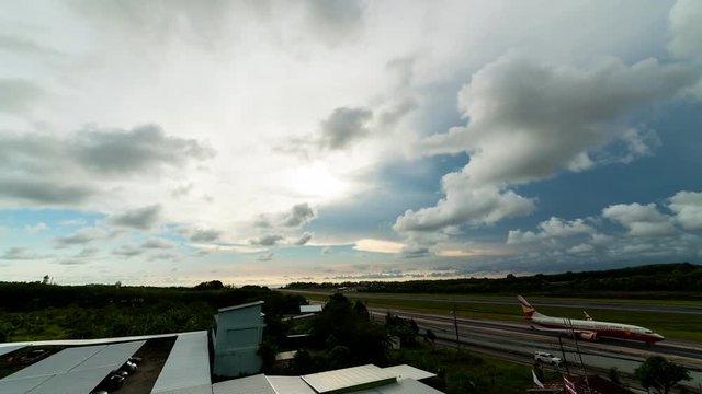 Time lapse of airport exterior and clouds moving fast in the sky