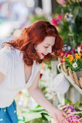 woman looks for flowers of a flower shop