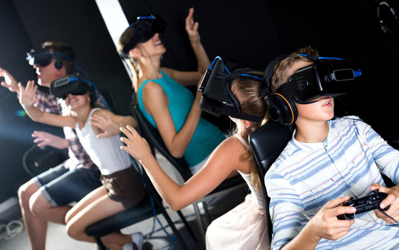 Family of five are watching video in virtual reality glasses