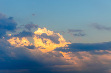 The sky is in the rays of the setting sun.