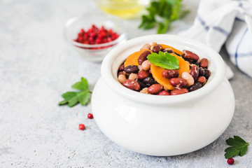Instant pot baked beans in a pot on concrete background. Selective focus, space for text. 