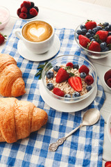 Continental breakfast with croissants and berries on checkered c