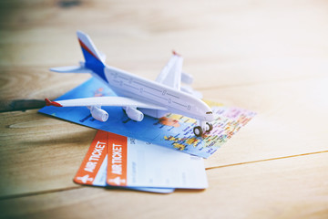 Plane model with world map and tickets as airplane traveling and tickets booking concept
