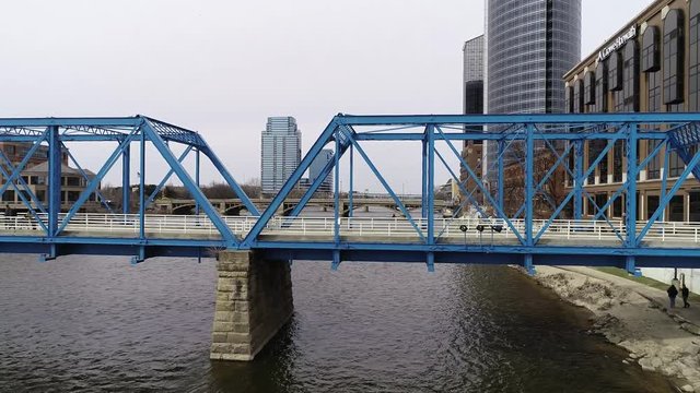 Aerial shot of people walking blue bridge 