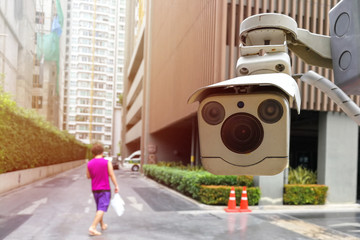 CCTV., security camera. Backdrop with view of people and condominium.