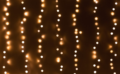Fototapeta na wymiar Bokeh abstract blurred lights vertical strings background
