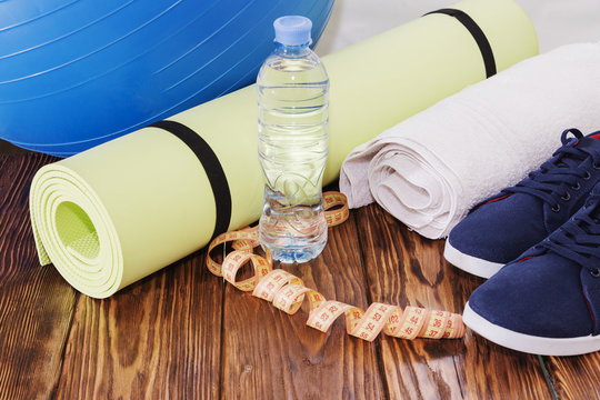 Sports equipment, Fit ball, yoga mat, and water bottle close up.