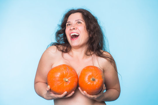 Pumpkins on a female breast - concept silicone breast and plastic surgery.