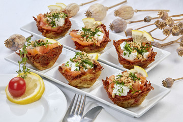 Salmon with cheese, pine nuts and lemon