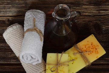 sea buckthorn oil, two home-made glycerin soaps with pieces of orange peel and lemon peeling, two towels with free space for text