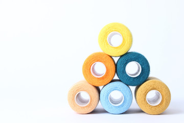 sewing thread of different colors isolated on white.
