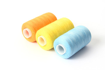 sewing thread of different colors isolated on white.