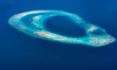 Aerial view of an atoll in the Maldives, Indian Ocean - obrazy, fototapety, plakaty