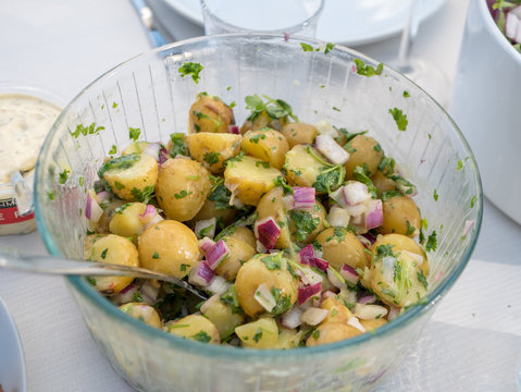 Swedish potato salad in a glass plate. Typical swedish dish in summer.