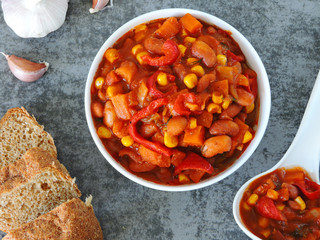 Beans with garlic in Mexican style in a white bowl