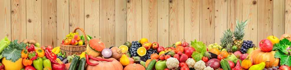 Rolgordijnen Panoramische foto gezonde groenten en fruit tegen lichte houten muur. © Serghei V