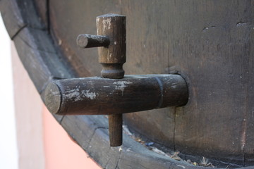 vintage brass faucet in an old oak barrel isolated