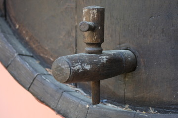 vintage brass faucet in an old oak barrel isolated