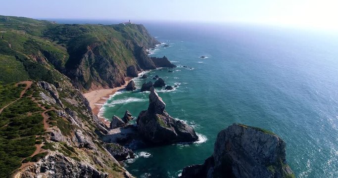 Aerial view from a drone of the beautiful Ursa Beach (Praia da Ursa) in Sintra, Portugal, with the Roca Cape (Cabo da Roca) on the background.
