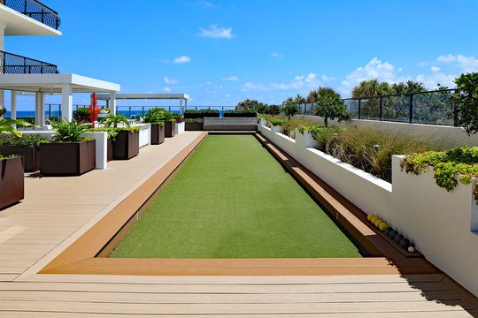 Inviting Upscale Bocce Ball Court With Artificial Turf, On A Rooftop Terrace.