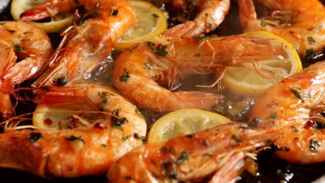 shrimp with lemon and herbs garlic fry in a frying pan