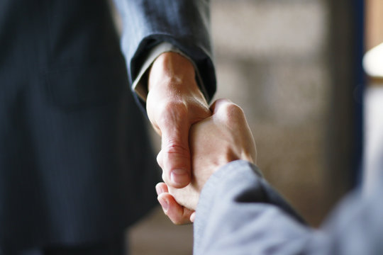 Business partnership handshake concept.Photo two coworkers handshaking process