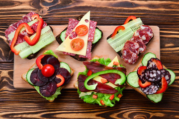 Sandwiches with different meat and vegetables.