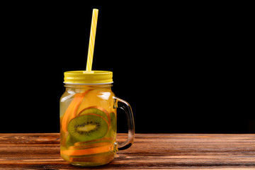 Infused water with kiwi and orange in jar