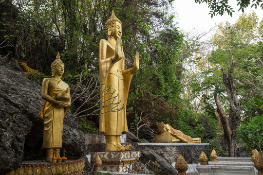 Three golden Buddha statues at the Mount Phousi (Phou Si, Phusi, Phu Si) in Luang Prabang, Laos.