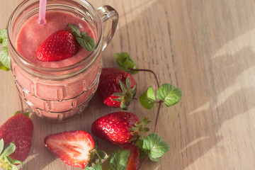 Strawberry Banana Smoothies in Glasses with Ingredients on wooden Table