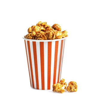 Delicious popcorn with caramel in paper bucket on white background