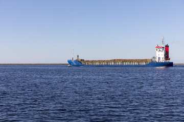 Fully loaded ship for the transport of wood is sent to the Baltic Sea