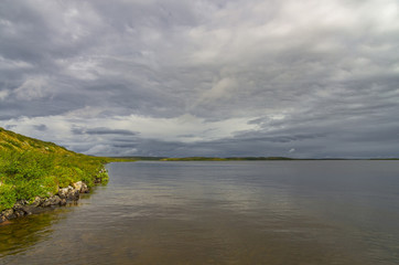 Wild lake among field in Norway mountains