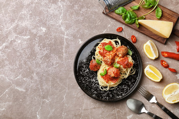 Delicious pasta with meatballs and tomato sauce on grey background, flat lay
