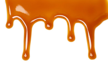 Delicious caramel sauce on white background