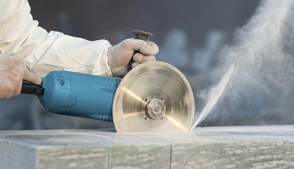 Worker cuts stone grinding machine