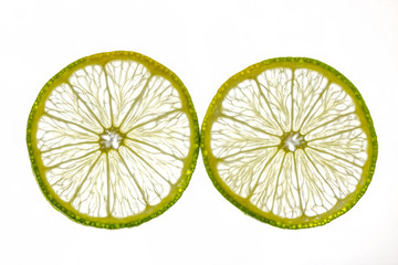Thin slices of lime on white background
