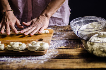 Dough dainted by the woman on the board