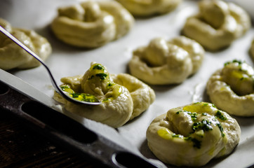 Dough dainted by the woman on the board