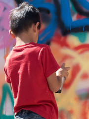 Street art graffiti child creating murals bright colors