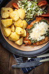 Fried chicken fillet with spinach and cheese.
