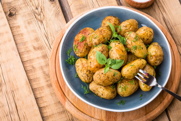 baked potatoes, blue plate, close-up, home kitchen, potatoes in the peel