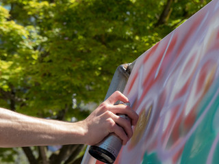 Background concept creativity tree green leaves painter hand aerosol closeup