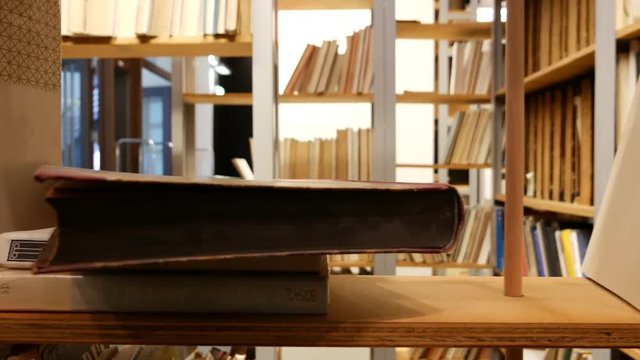 Shelf with books - Searching for a book in a library