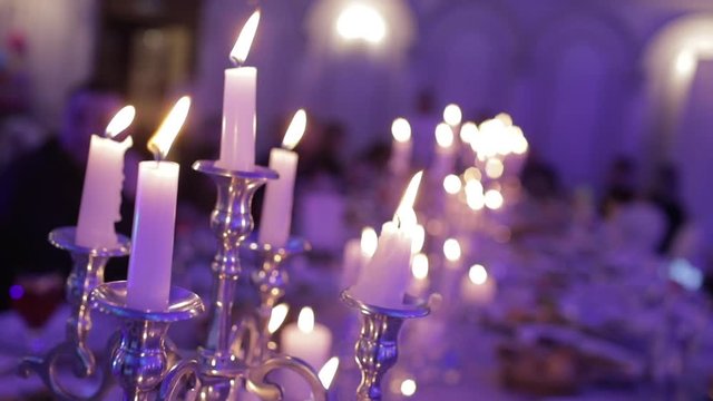 Festive candles at dinner, a large long table with candlesticks