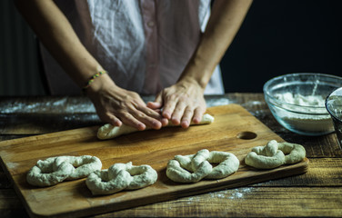 Dough dainted by the woman on the board