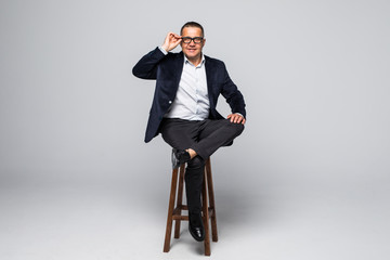 Senior Businessman sitting in chair isolated on white background